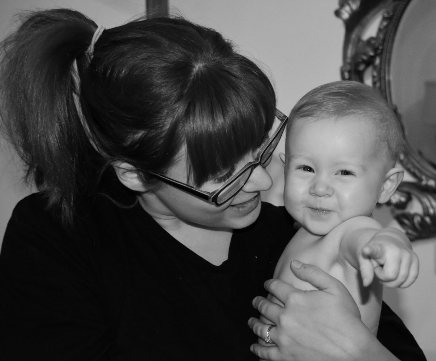 Our baby Isabelle pointing at me whilst being held by her mother