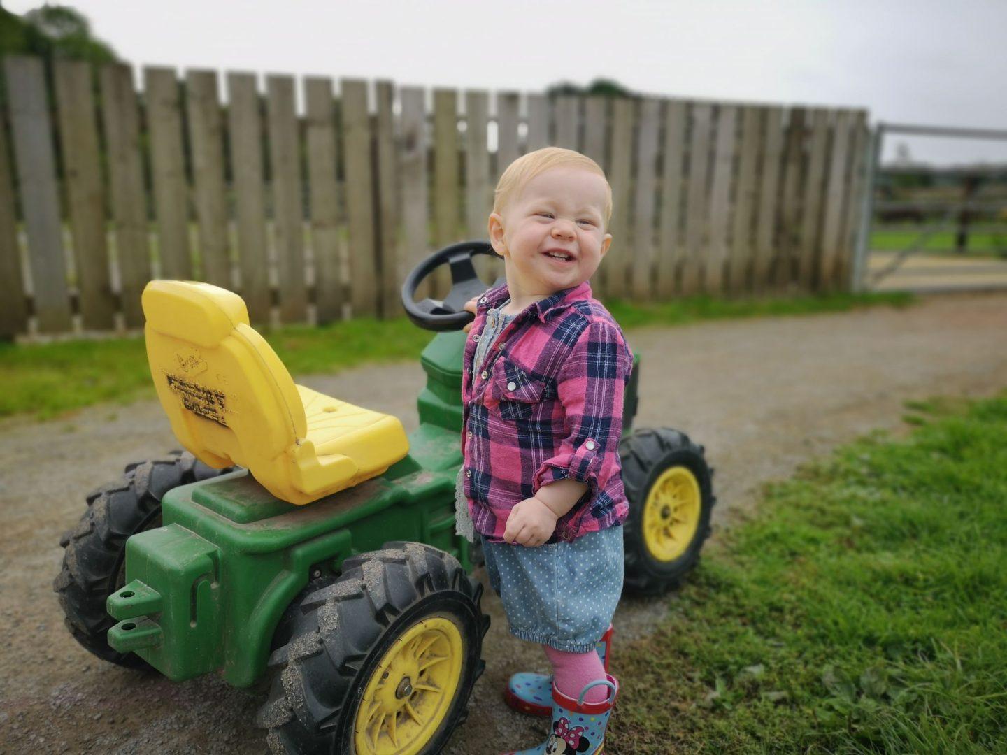 Our daughter with one of the rideable tractors at cefn mably farm